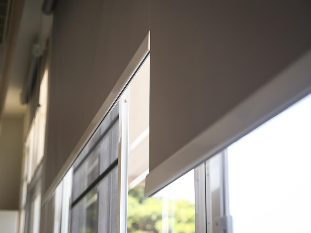 Close up of roller blinds that are open halfway