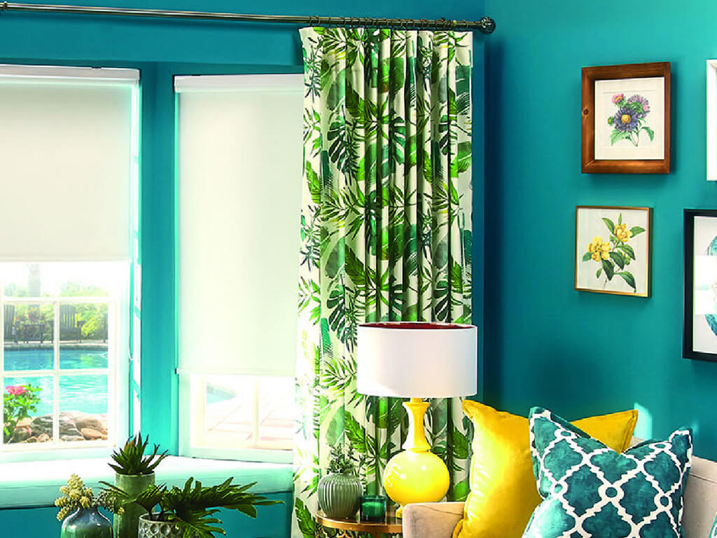 Yellow and green room decor showcasing light green roller blinds and leaf patterned curtains