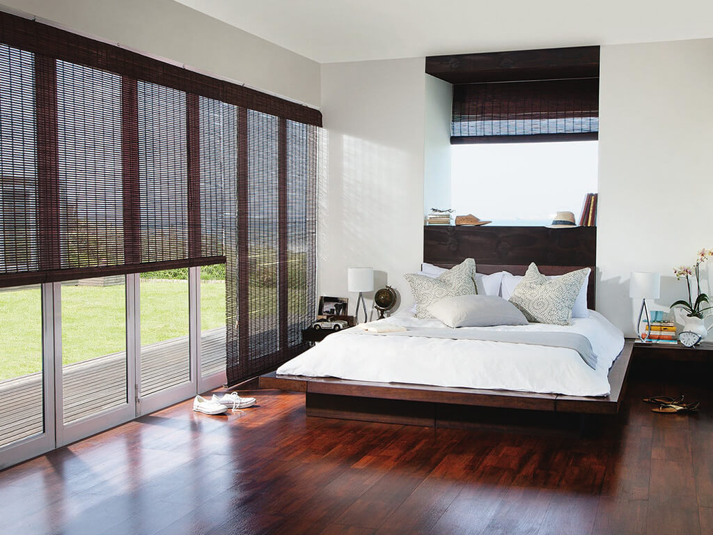 Sleek bedroom design showcasing large doors with bamboo blinds